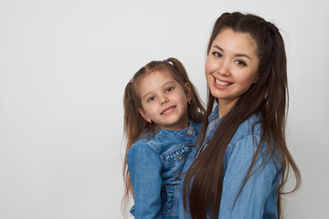 Happy woman and child girl 5-6 years old having fun