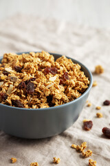Homemade Granola with raisins and almonds  in a Bowl, side view. Close-up.
