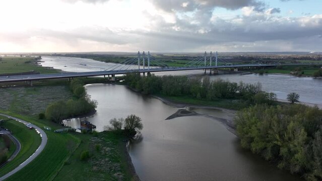 Tacitusbrug bij Ewijk modern suspension bridge crossing the river Waal near Nijmegen, the Netherlands Holland Europe. Valburg and Ewijk. Traffic highway over waterway. Holland.