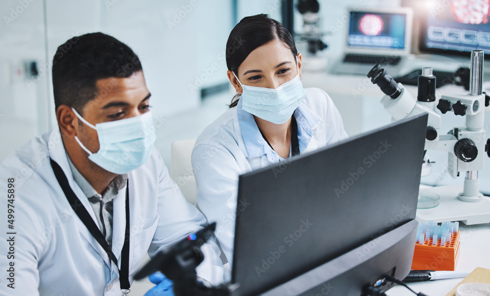 Poster everyday we get closer to our goal. shot of two young researchers using a computer in a laboratory.