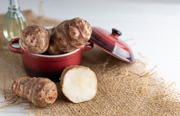 Trendy Winter vegetable. Jerusalem artichoke one of the forgotten vegetables who has become trendy again, on a wooden table.