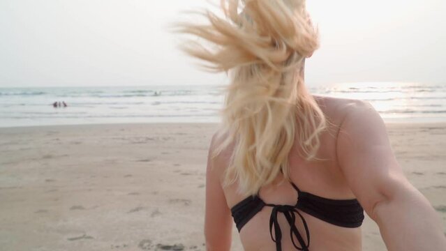 Follow me. Girl on the beach. Slow motion video.