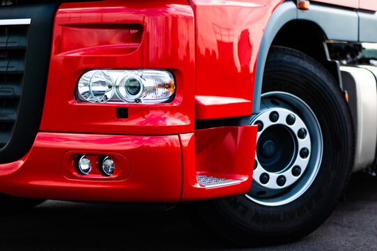 Red semi truck closeup on headlight