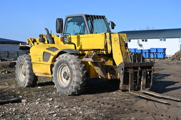 Fototapeta na wymiar Photo tractor loader yellow outdoors