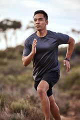 Fototapeta premium Running clears the mind of all worries. Shot of a young man exercising in nature.