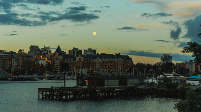 Full Moon At Dusk Over Victoria, BC, Canada, Harbour And Waterfront.