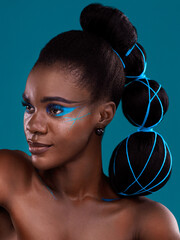 The most beautiful face there ever was. Studio shot of a beautiful young woman posing against a turquoise background. © Valerie Murray/peopleimages.com