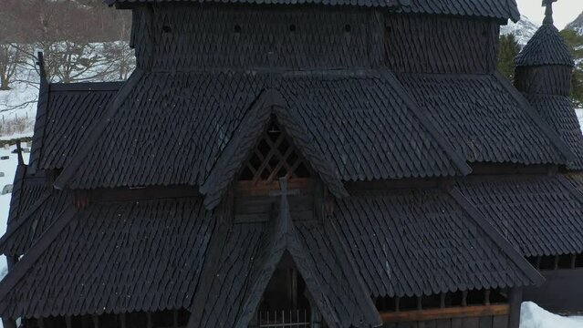 Borgund stave church from middle age - Detailed ascending aerial from entrance to top of tower