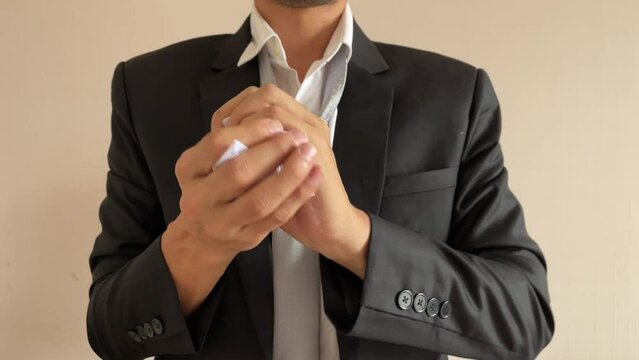 Frustrated asian male businessman professional crumpling paper with written message &ldquo;PRIVILEGE&rdquo; word. Man in suit and tie having nervous breakdown furiously throwing crumpled paper in office at work