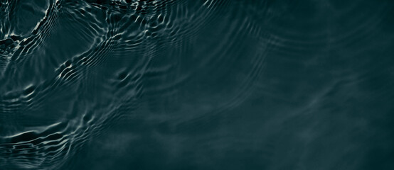 Black transparent clear calm water surface texture with ripples, splashes. Abstract nature banner...