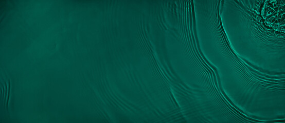 Transparent dark green clear water surface texture with ripples and splashes. Abstract summer...