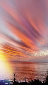 Vertical slow motion video of sunrise of the ocean