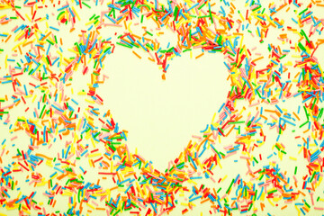 Simple concept flat lay with a heart made of sugar sprinkles.