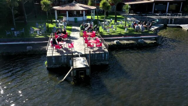 People at Sunny Riverside Terrace Bar in Early Spring, Aerial Orbit