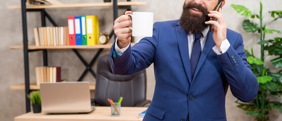 Fototapeta premium Professional man crop view talking on mobile phone holding cup for copy space, advertisement