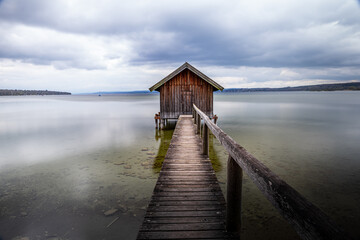 Traditional boathouse at lake Ammersee near Munich, Bavaria, Germany at sunrise.