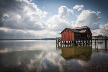 Fototapeta premium Traditional boathouse at lake Ammersee near Munich, Bavaria, Germany at sunrise.