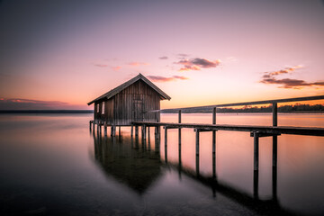 Fototapeta na wymiar Traditional boathouse at lake Ammersee near Munich, Bavaria, Germany at sunrise.