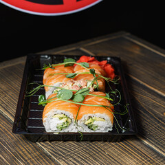 Bright sushi on a dark wooden background	