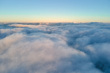 Aerial view from high altitude of earth covered with puffy rainy clouds forming before rainstorm