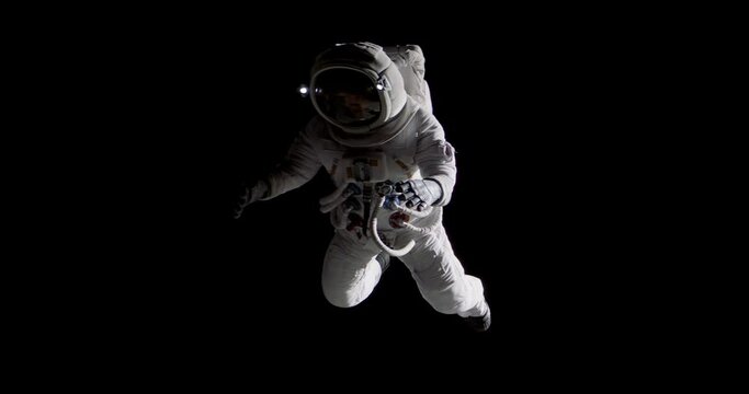 Full portrait of Caucasian female astronaut during spacewalk, black deep space background