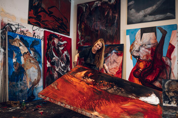 Female painter artist painting and creating her art in a creative studio