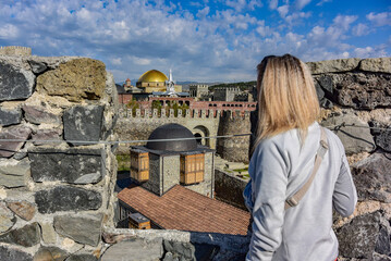 Fototapeta premium A girl on the background of a view of the Rabati fortress in Akhaltsikhe, Georgia 2019