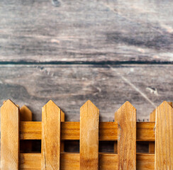 Part of a wooden fence on a gray background