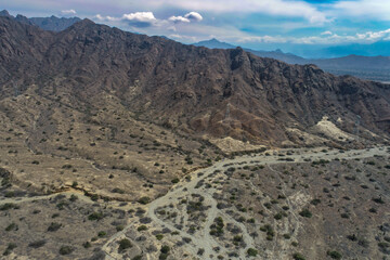 arid mountains in them you can see power towers and highways.
