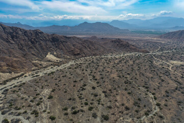 arid mountains in them you can see power towers and highways.