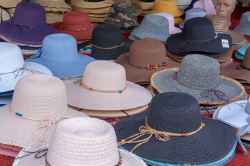 Lots of womens hats on the street stall.