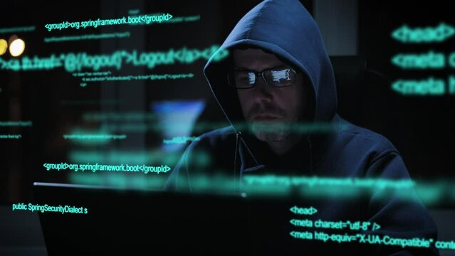 An experienced hacker works with code when breaking into security systems. A programmer is looking for illegal work on the dark web.