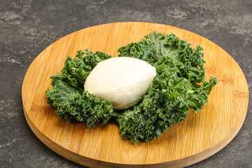 Soft mozzarella cheese over board