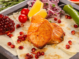 Grilled salmon steaks served lemon