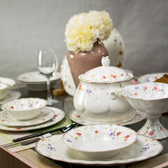 white dinnerware with a beautiful pattern on the table