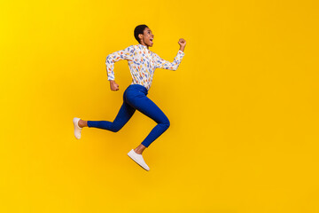 Full length profile portrait of excited active person hurry rush fast empty space isolated on yellow color background
