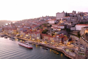 Amazing panorama of Porto lying by Douro River in sunset light, Portugal
