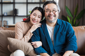 Asian Middle-aged Asian couple smiling at the camera. Family couple portrait - obrazy, fototapety, plakaty
