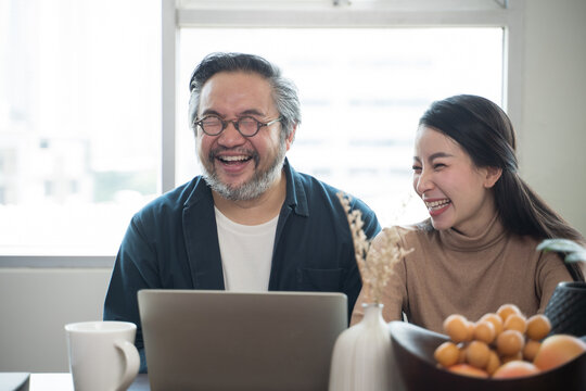 Asian Middle-aged Asian Couple Laughing Together At Home