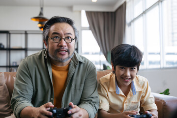 Son and dad playing video game at home