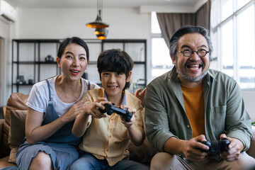 Son and dad playing video game at home