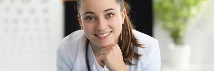 Portrait of smiling woman ophthalmologist in office of clinic