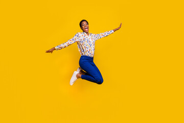Full body photo of crazy carefree person hands wings have fun isolated on yellow color background