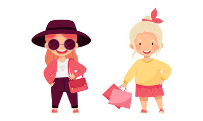 Cute beautiful little girls in fashionable outfit set. Girls choosing and buying fashionable clothes cartoon vector illustration