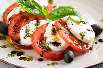 Closeup on caprese salad with olives and basil
