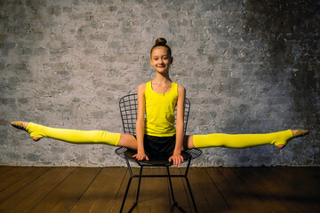 Young gymnast girl stretching and training. Sport and healthy lifestyle concept. Stretching...