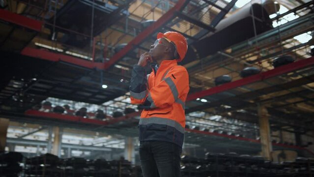 Industrial supervisor thinking wearing safety uniform at modern warehouse.