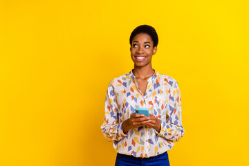 Photo of cheerful person look interested empty space think minded isolated on yellow color...