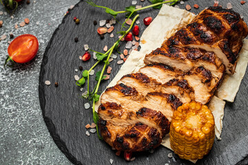 Ketogenic diet food, grilled chicken fillet. Barbecued chicken breasts on slate plate, Roasted Chicken fillet with vegetables, healthy meal concept, top view