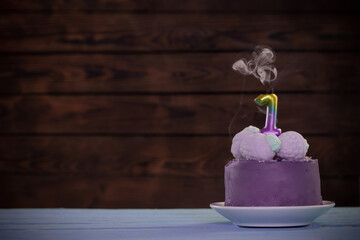 birthday cake with candle on dark wooden background 